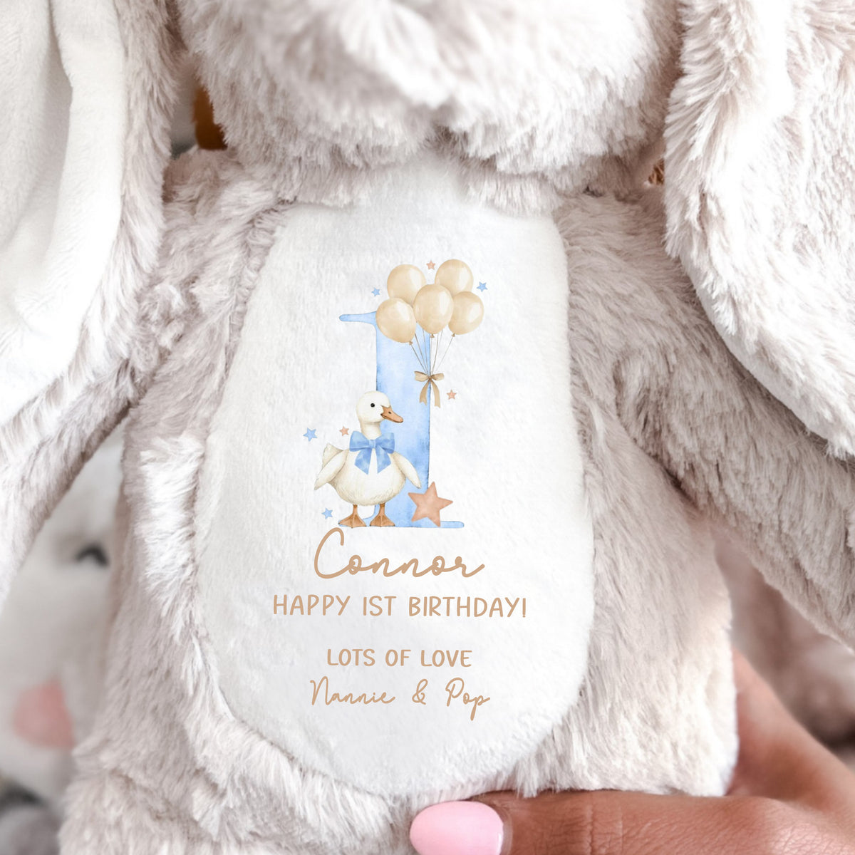 Close-up of soft plush bunny showing custom name and message
