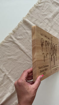 A wooden cheese board engraved with your child's drawing.