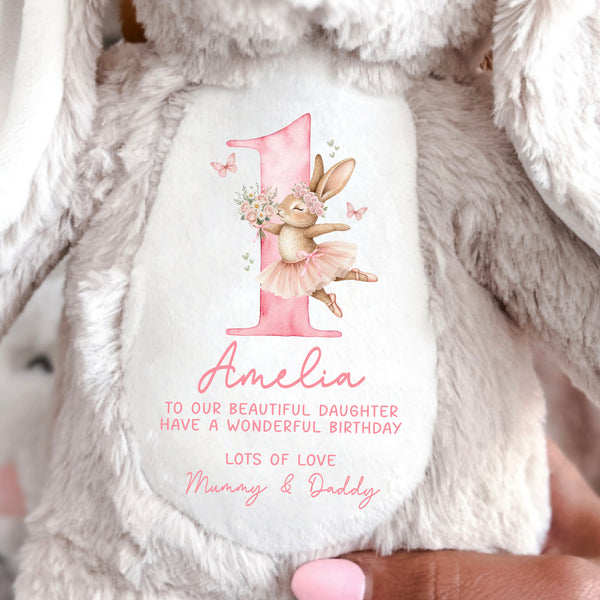 Close up of a beige bunny with Happy 1st Birthday message on the front.