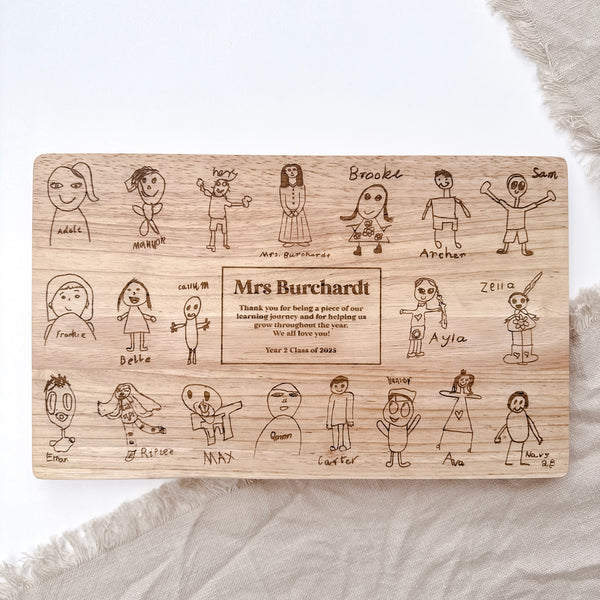 A personalised cheese board with kids drawings engraved