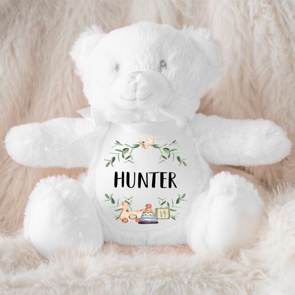 A personalized white teddy personalised a baby name and cute baby toys.